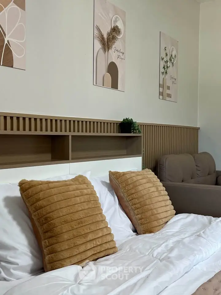Cozy bedroom with stylish decor and plush pillows, perfect for relaxation and comfort.
