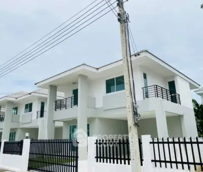 Modern two-story house with sleek design and spacious balconies in a serene neighborhood.