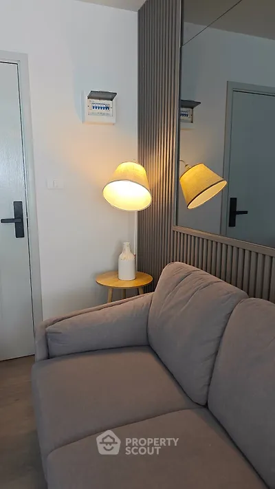 Cozy living room corner with modern sofa and stylish lamp