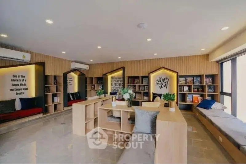 Spacious modern library with cozy seating and stylish decor in a real estate property.