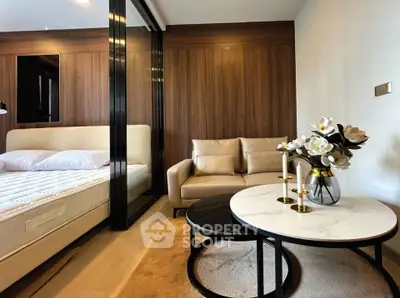 Luxurious modern bedroom with elegant decor and cozy seating area, featuring a plush bed and stylish coffee table.