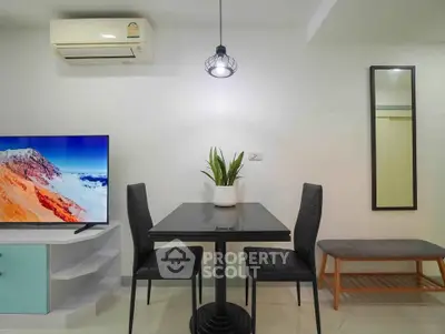Modern living room with sleek furniture and wall-mounted TV, perfect for cozy gatherings.