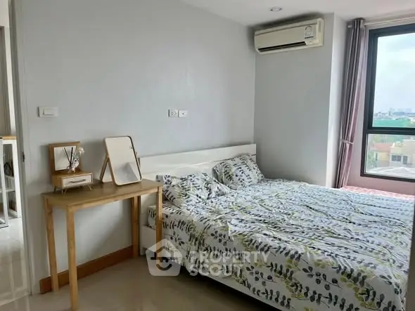 Cozy bedroom with air conditioning and city view window