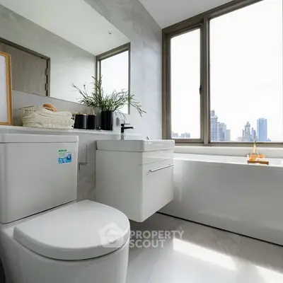 Modern bathroom with city view, featuring sleek fixtures and a luxurious bathtub.