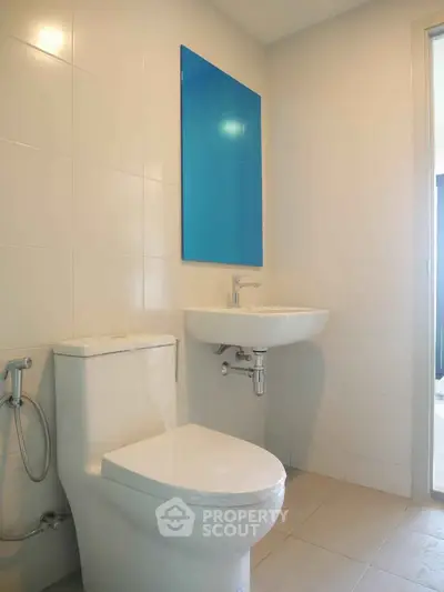 Modern bathroom with sleek white fixtures and minimalist design