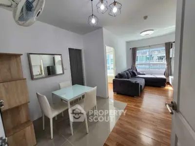 Modern open-plan living room with dining area and large windows