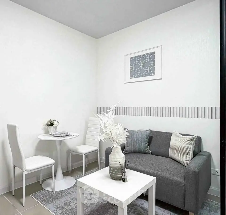 Modern minimalist living room with gray sofa and white decor