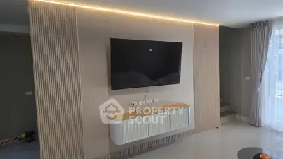 Modern living room with sleek TV setup and elegant lighting