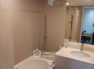 Modern bathroom with sleek fixtures and a bathtub, ideal for relaxation.