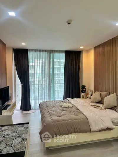 Modern bedroom with cozy decor and large windows in a stylish apartment