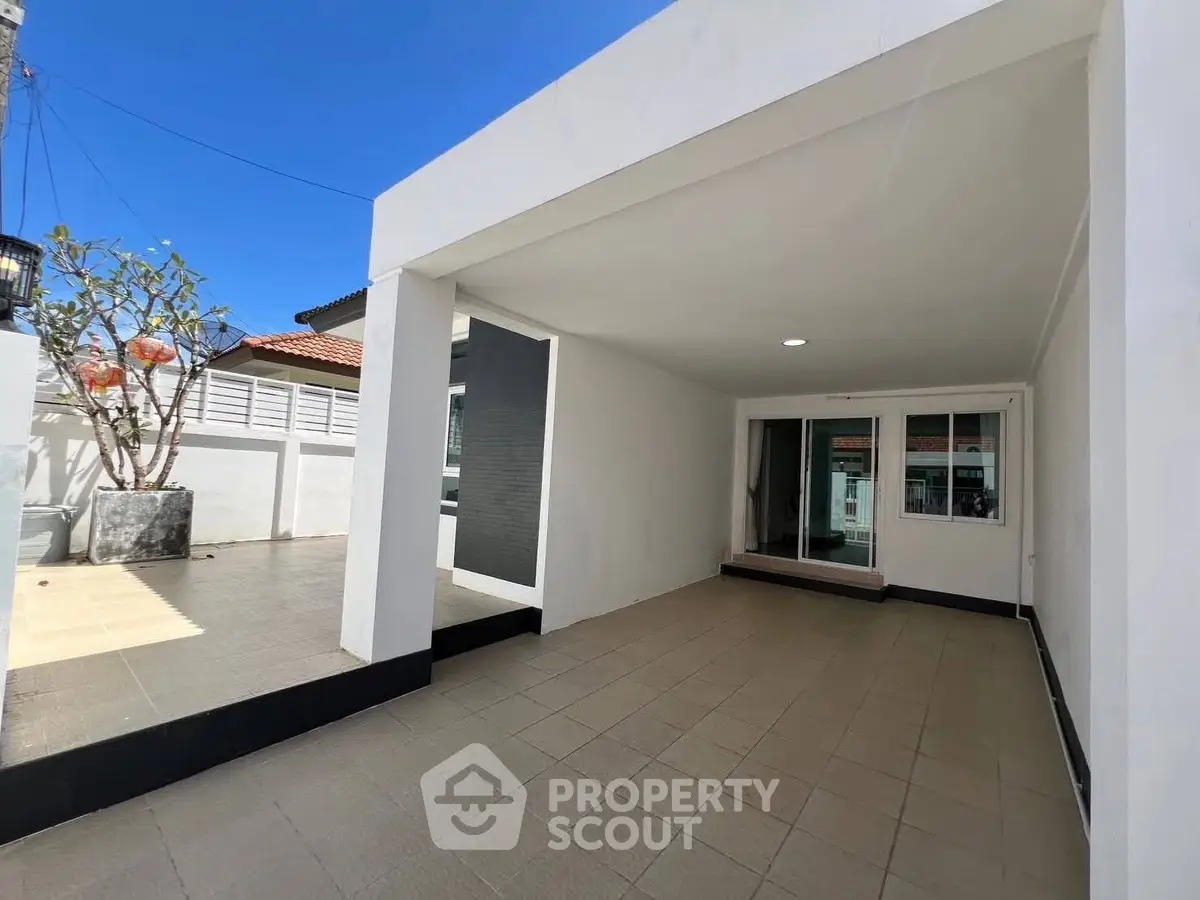 Spacious modern exterior with covered patio and tiled flooring, perfect for outdoor relaxation.