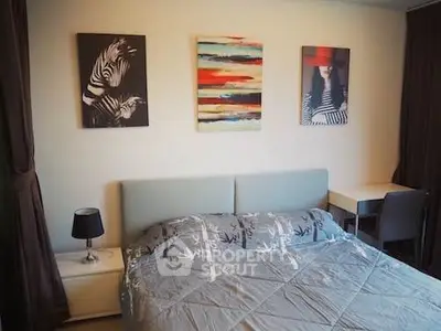 Cozy bedroom with modern decor and stylish artwork, perfect for relaxation and comfort.