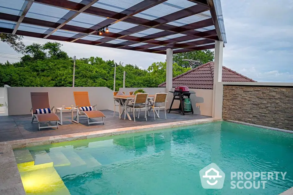 Luxurious outdoor pool area with stylish patio furniture and BBQ setup