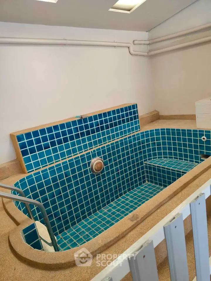 Unique indoor pool with blue tiles in a modern home setting.