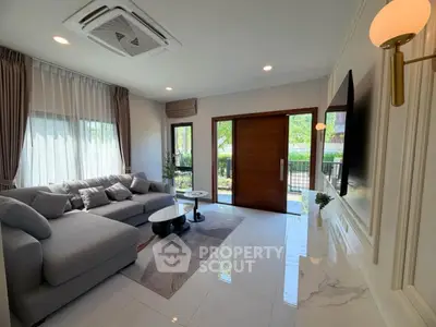 Spacious modern living room with elegant decor and large windows for natural light.