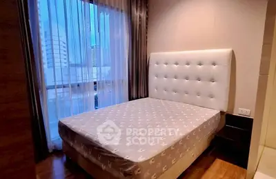 Cozy bedroom with large window and modern decor in urban apartment