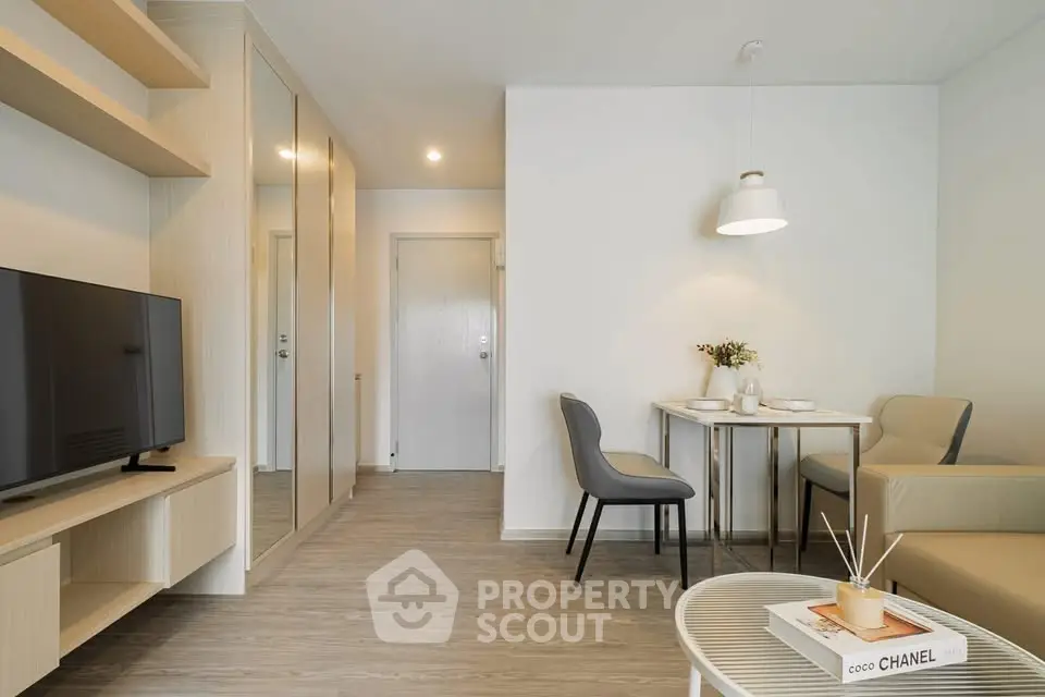 Modern living room with sleek furniture and dining area in stylish apartment.
