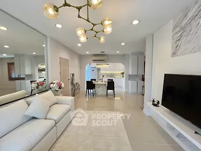 Modern living room with elegant decor and open layout leading to dining area.