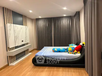 Modern bedroom with sleek design and cozy atmosphere, featuring elegant curtains and stylish bed.