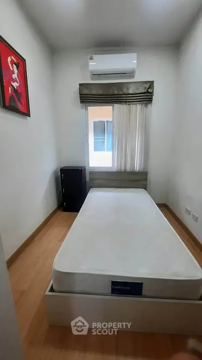 Cozy minimalist bedroom with air conditioning and modern decor