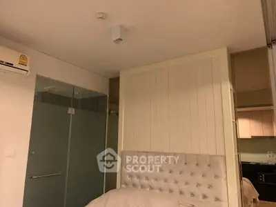 Cozy bedroom with modern design and glass partition in stylish apartment