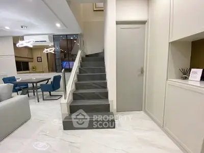 Modern interior with sleek staircase and elegant dining area