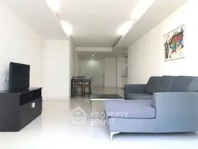 Spacious modern living room with sleek furniture and stylish decor, perfect for comfortable living.