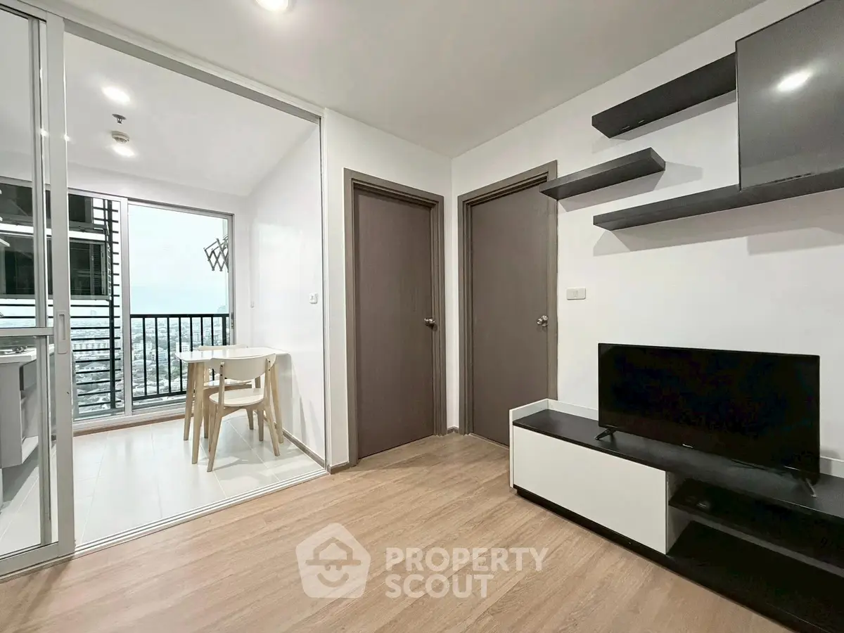 Modern living room with sleek TV unit and balcony view in stylish apartment