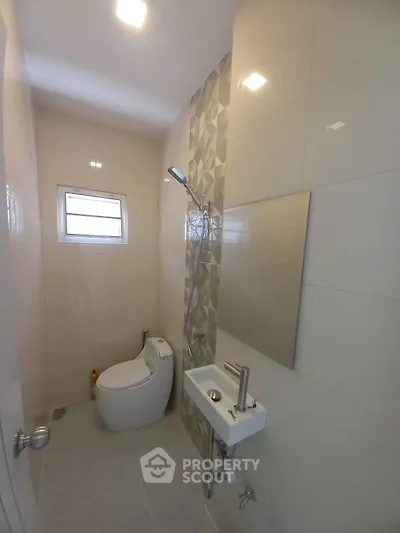 Modern compact bathroom with sleek fixtures and stylish tile design.