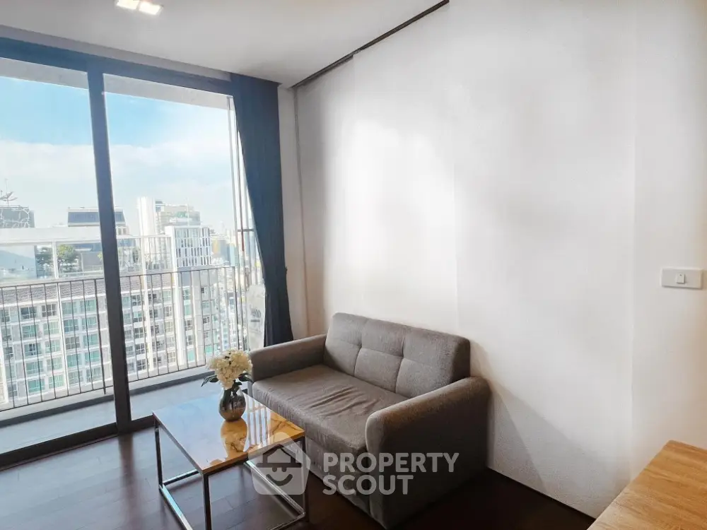 Modern living room with city view and cozy sofa in high-rise apartment