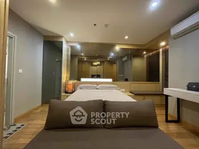 Luxurious bedroom with modern design and ambient lighting, featuring a comfortable bed and stylish decor.