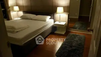 Cozy bedroom with modern decor and warm lighting, featuring a comfortable bed and stylish nightstands.
