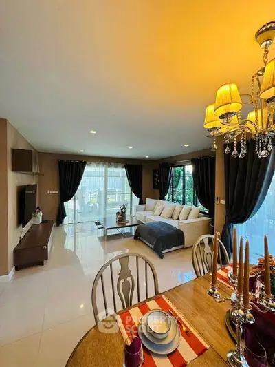 Luxurious open-plan living and dining area with elegant decor and ample natural light.