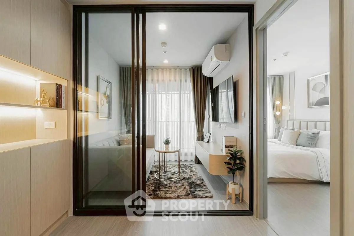 Modern living room with glass partition and cozy bedroom view