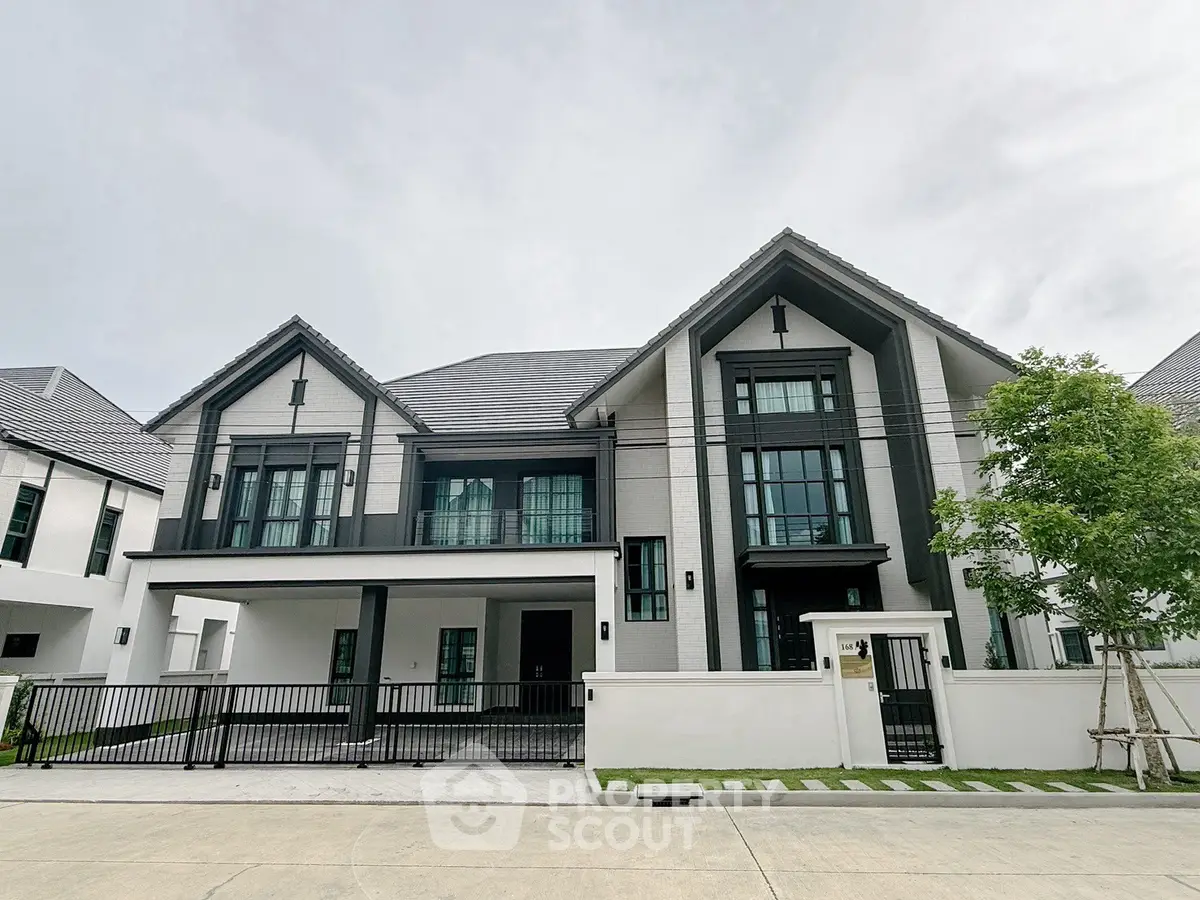 Stunning modern two-story house with sleek design and spacious driveway in a serene neighborhood.