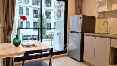 Modern kitchen with sleek fridge and balcony view in stylish apartment