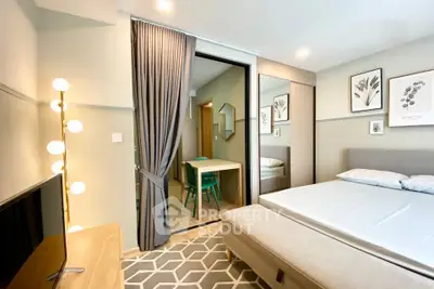 Modern bedroom with stylish decor and adjoining dining area in a cozy apartment.