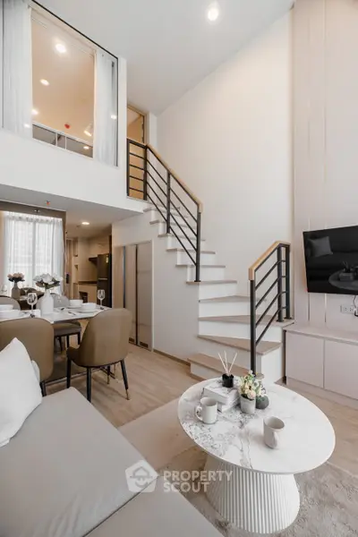 Modern duplex living room with elegant staircase and stylish decor