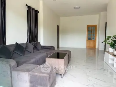 Spacious living room with modern gray sofa and sleek marble flooring