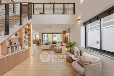 Spacious modern living room with elegant staircase and cozy seating area