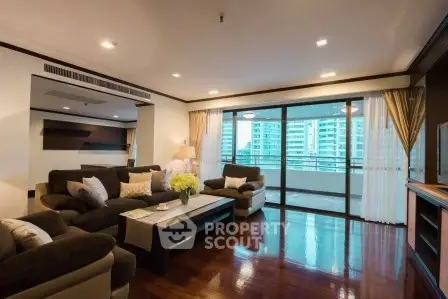 Luxurious living room with elegant decor and large balcony view in modern apartment.