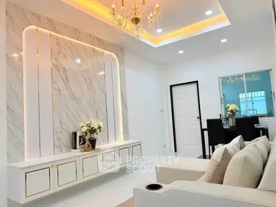 Luxurious modern living room with elegant chandelier and marble accent wall