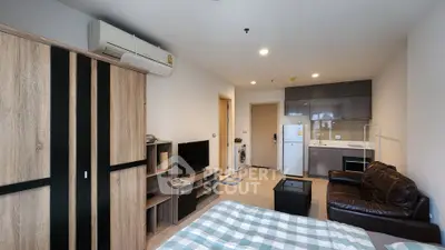Modern studio apartment with open layout, featuring a cozy living area, compact kitchen, and stylish furnishings.