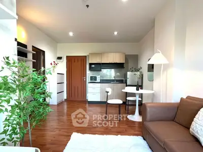 Modern living room with open kitchen, cozy seating, and stylish decor