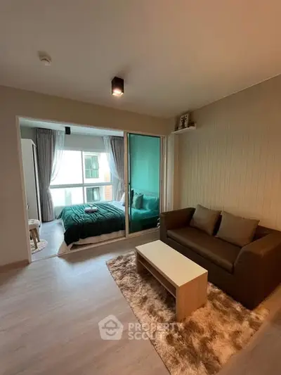 Modern apartment with cozy living room and stylish bedroom, featuring sleek furniture and natural light.