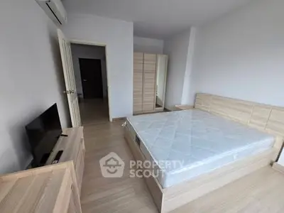 Spacious bedroom with modern wooden furniture and natural light