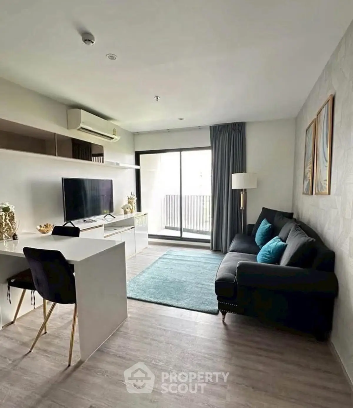 Modern living room with stylish decor and balcony access in a contemporary apartment.