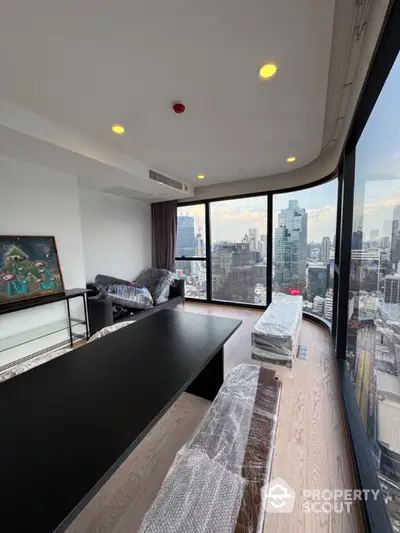 Stunning high-rise living room with panoramic city views and modern furnishings.