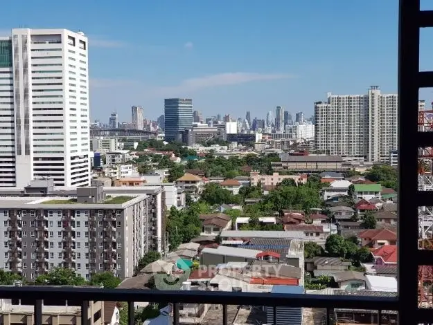 Stunning cityscape view from a high-rise balcony showcasing urban skyline and residential buildings.