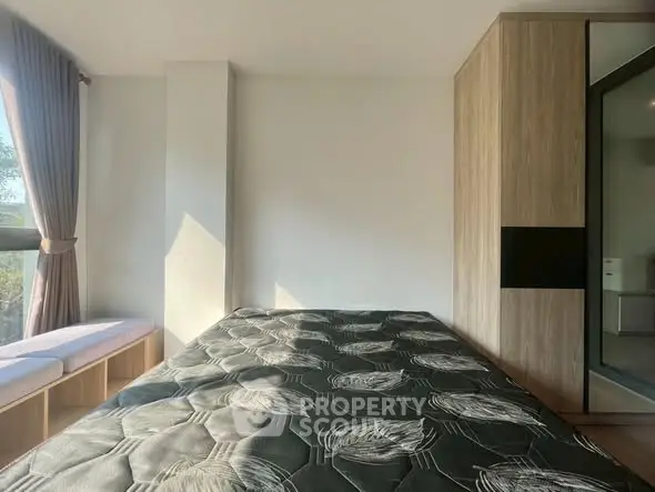 Modern bedroom with large window and built-in wardrobe